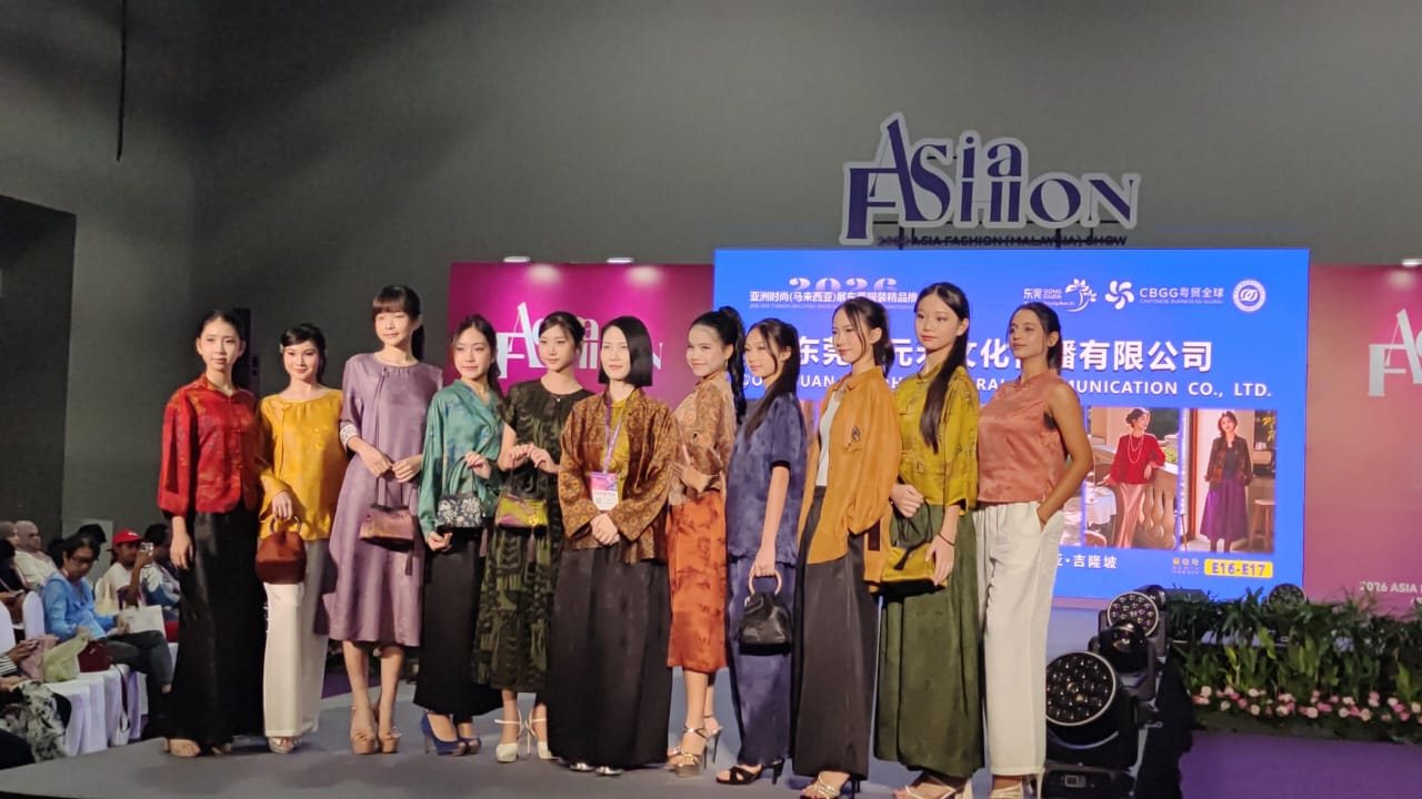 Line-up on stage beneath the Asia Fashion sign