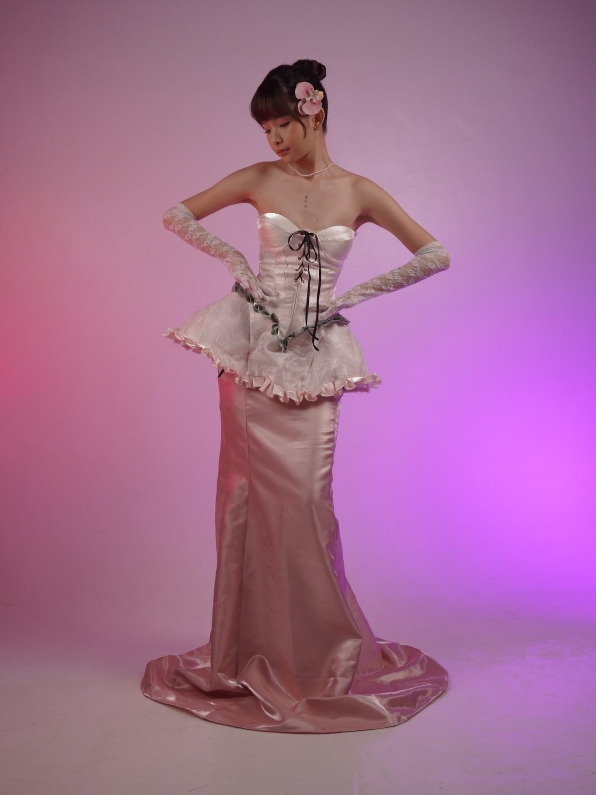 Lace-up corset gown, looking down, hands on hips