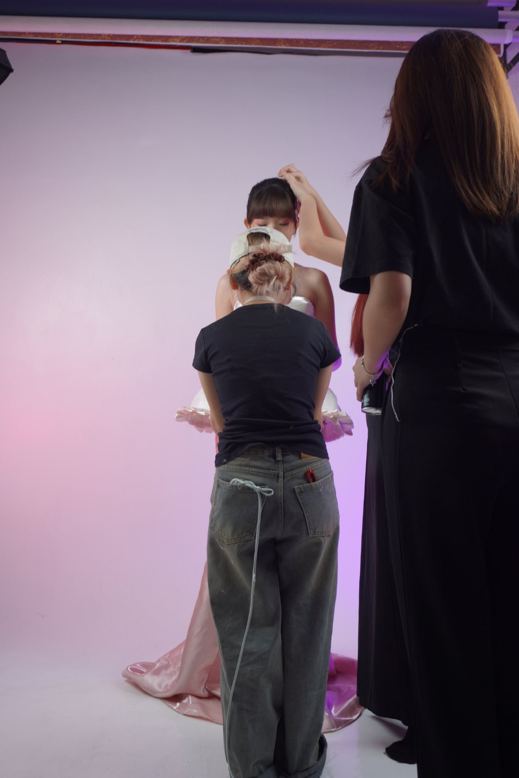 Behind the scenes: hair and makeup touch-ups before a take