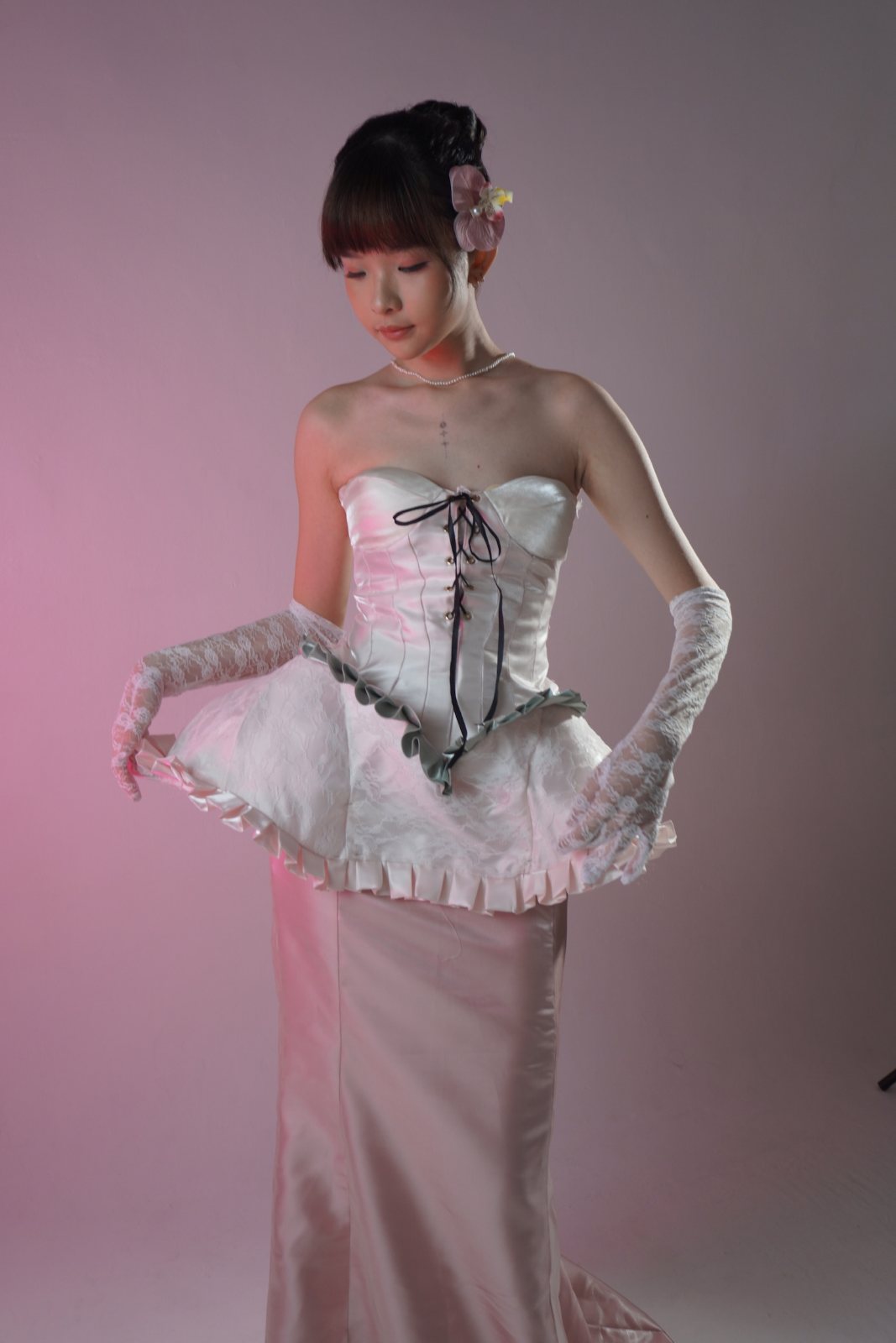Looking down, gloved hands holding the peplum
