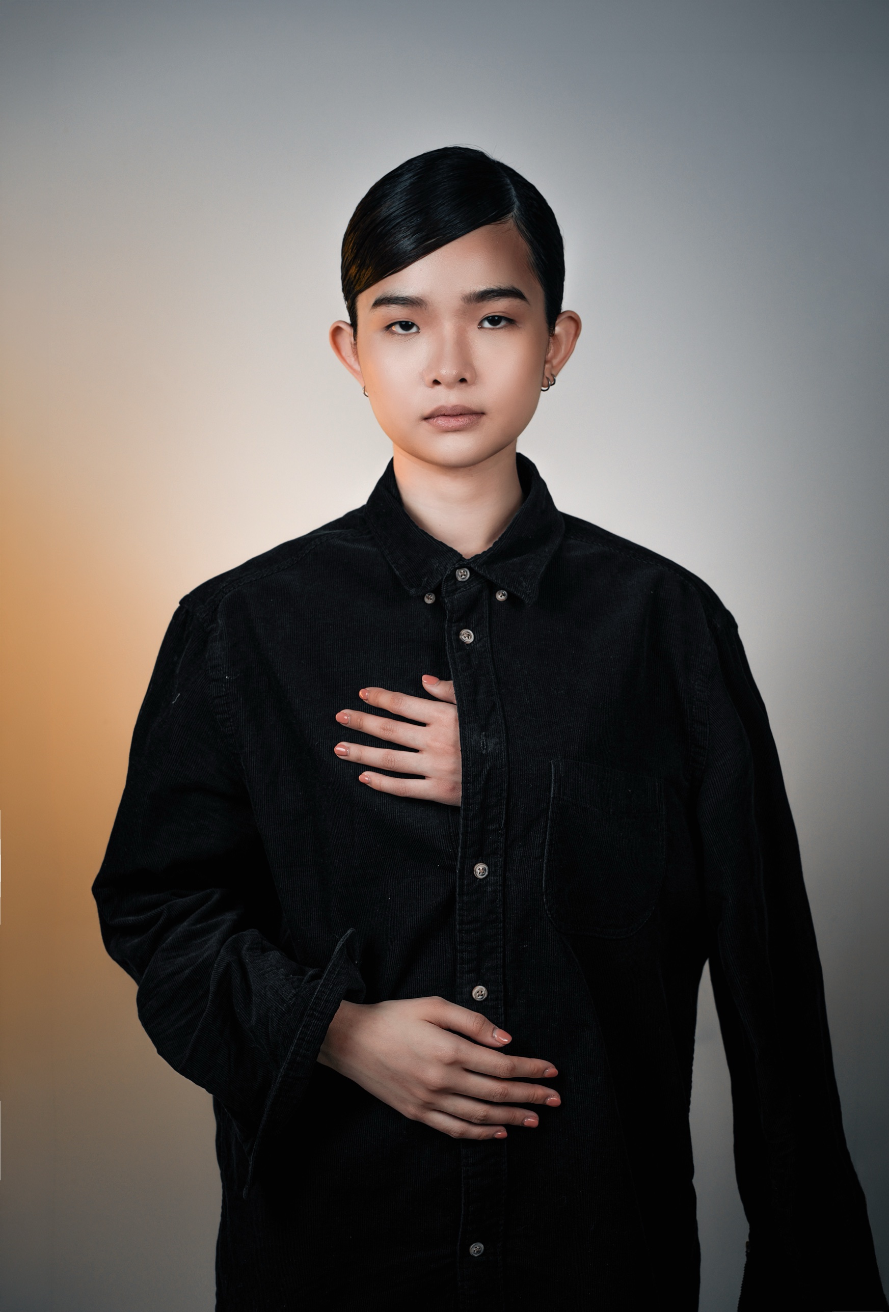 Hand on the chest, black corduroy shirt