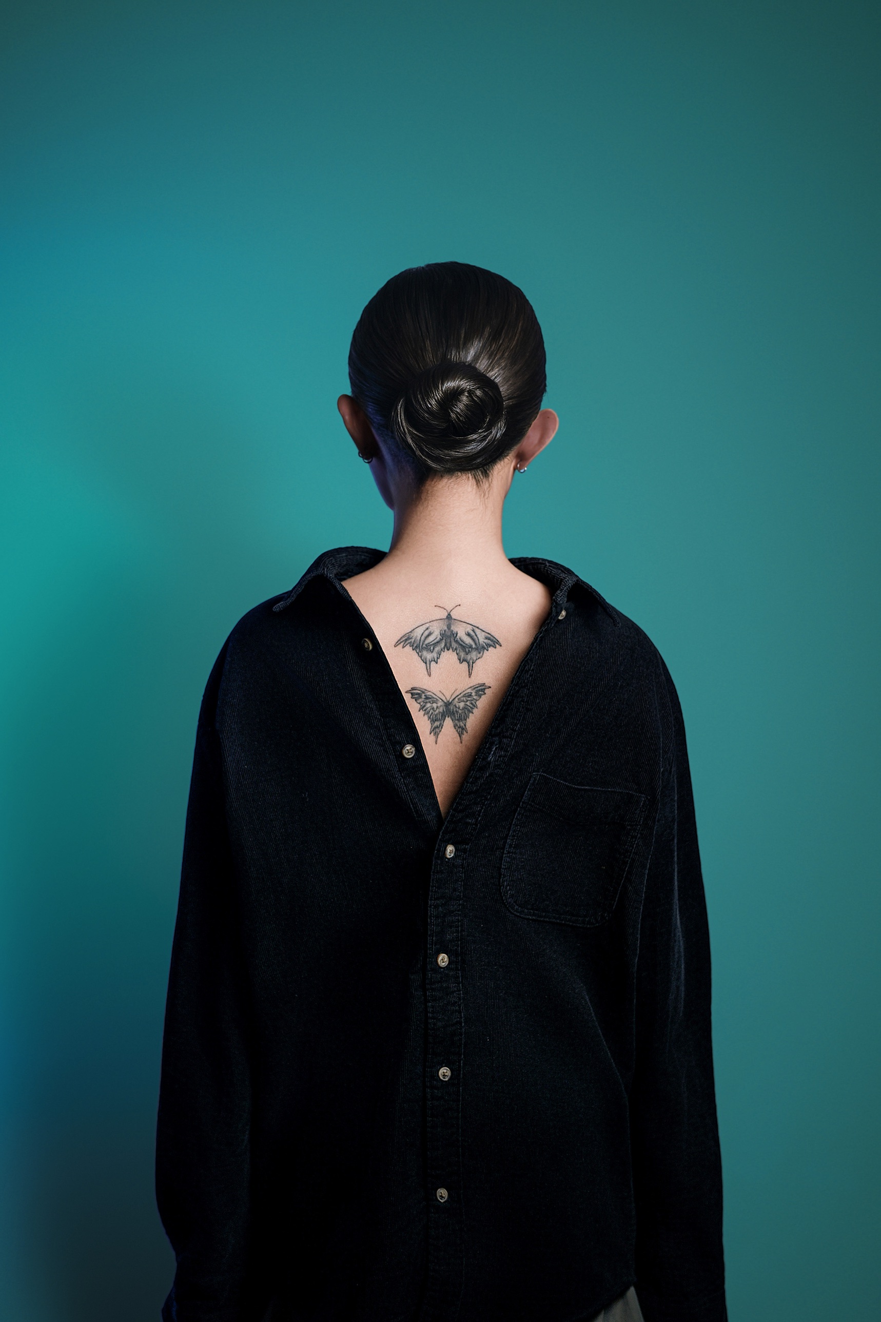 Back view: open shirt and butterfly tattoos