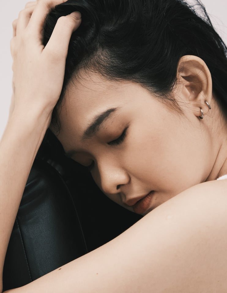 Eyes closed, resting on arm