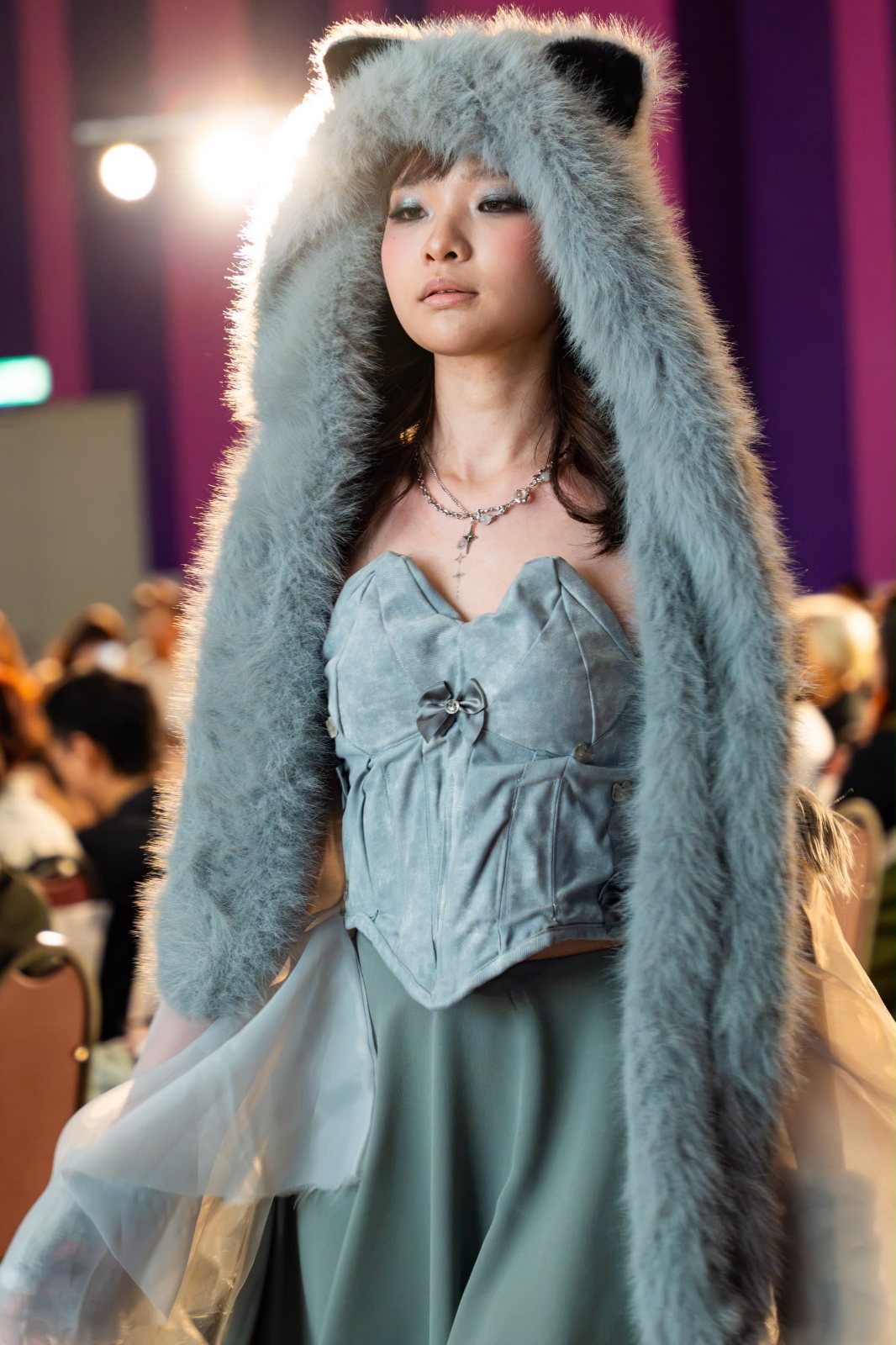 Close-up on the runway, backlit fur hood