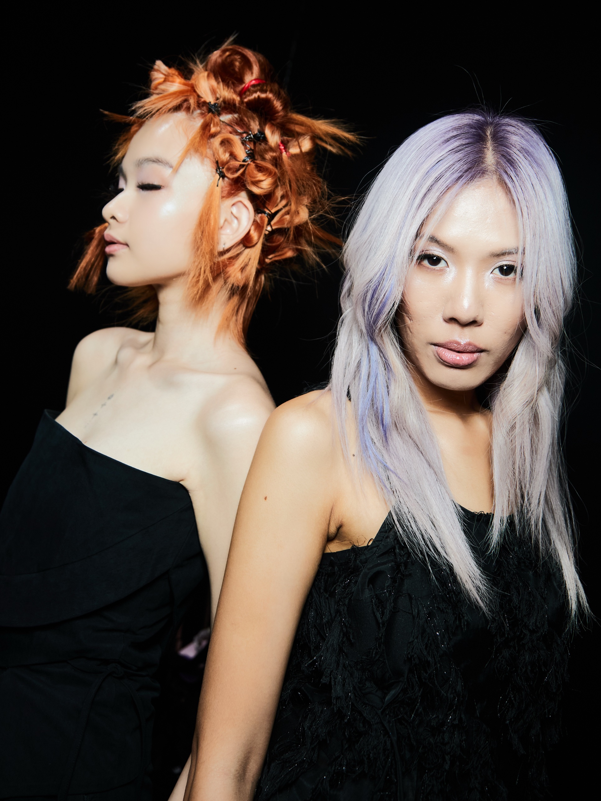 Backstage portrait with Ashlyn: copper knots, eyes closed, beside long lilac hair