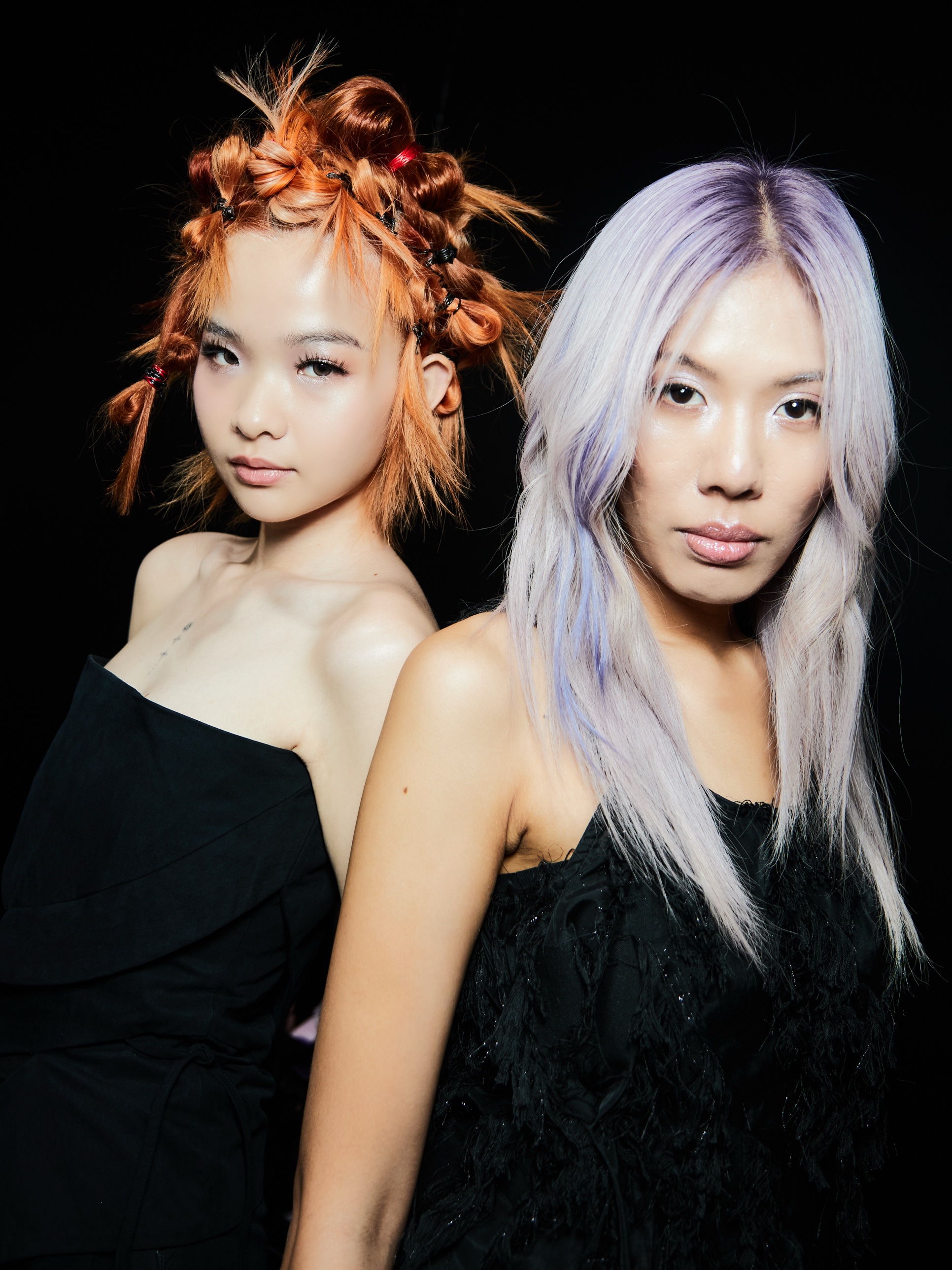 Backstage portrait with Ashlyn: copper knots and long lilac hair, both facing the camera
