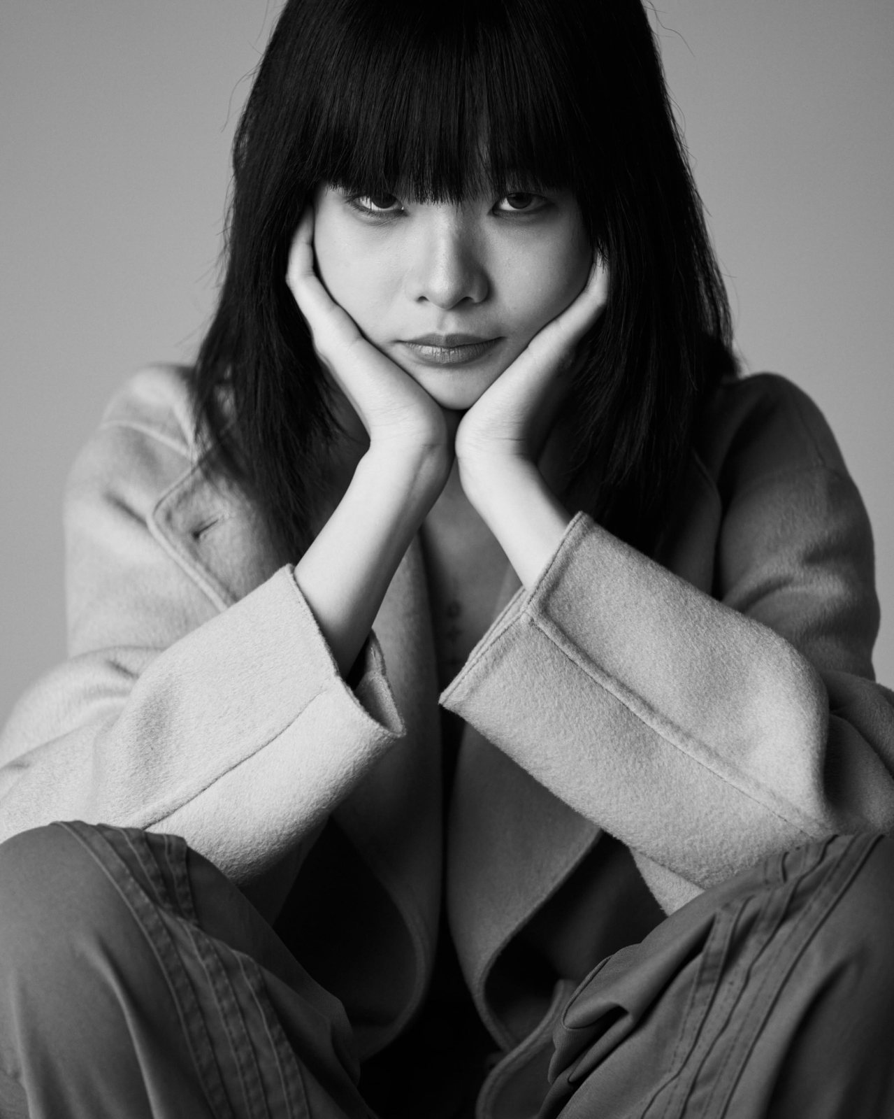 Studio portrait, black and white, hands on face