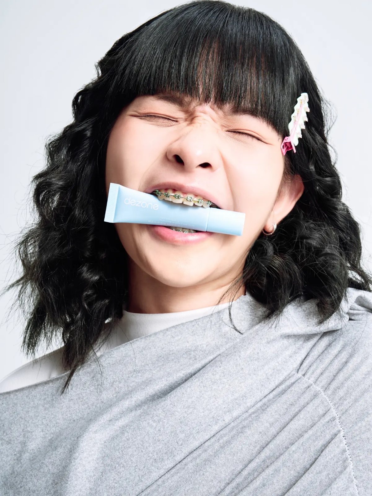 Lipstick campaign, tube held between teeth