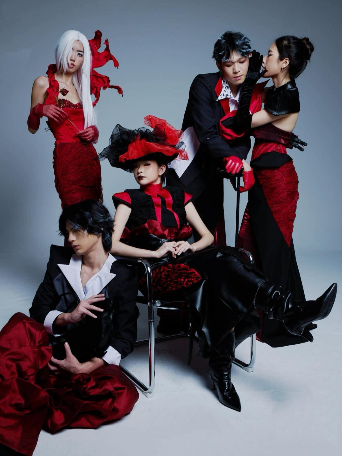 Five looks in red and black, grouped around a chrome chair